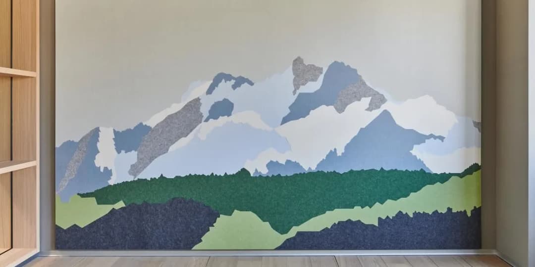 view of custom acoustic wall panelling that shows the Swiss alps in 8 coloured felt panels
