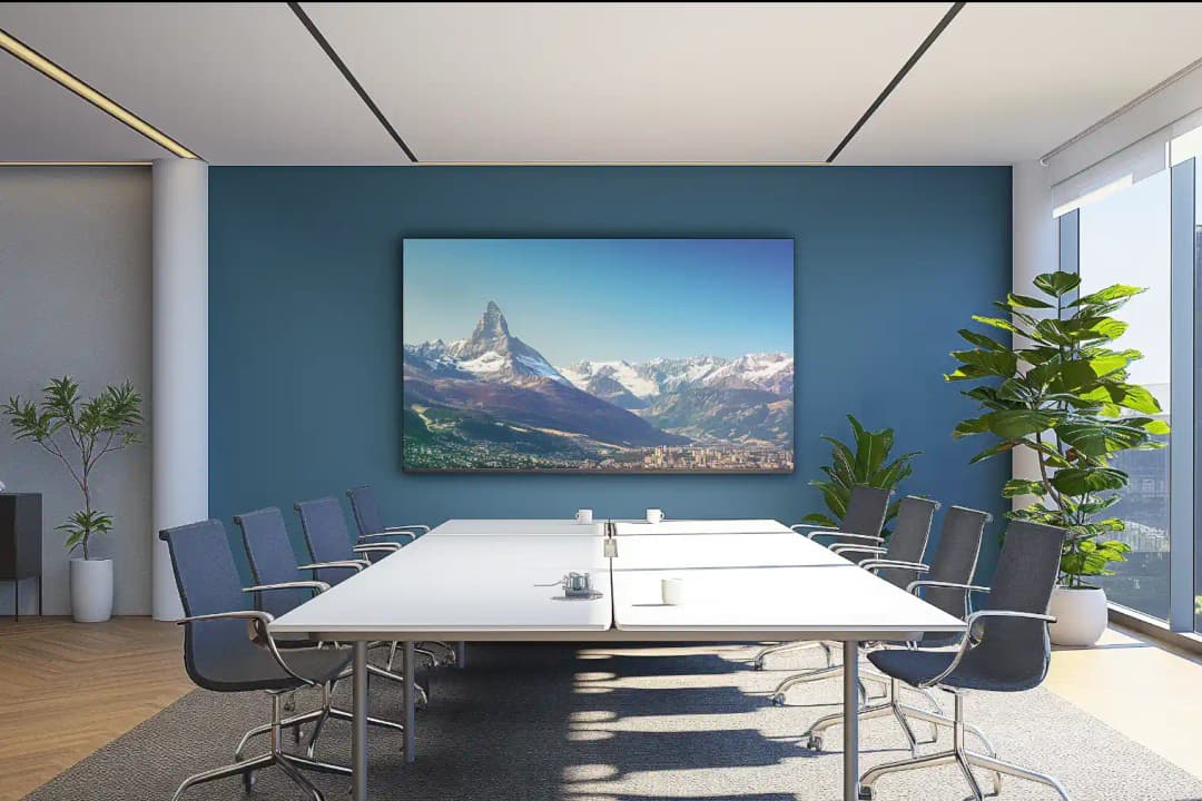 modern meeting room with large glass windows on one side, there is a large table in the centre with an acoustic artwork panels on the back wall