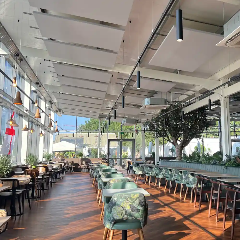 Modern Garden centre restaurant with large windows, Sunlight streams in, creating a bright and airy atmosphere.