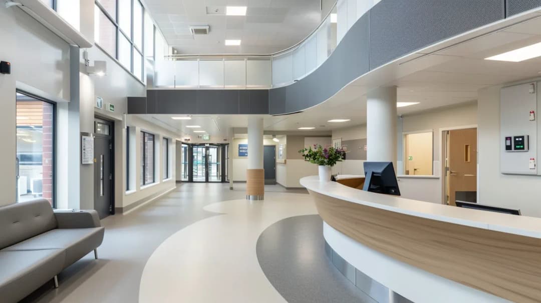 circulation entrance to hospital with clean look grey acoustic panels installed below banister on second floor of healthcare facility