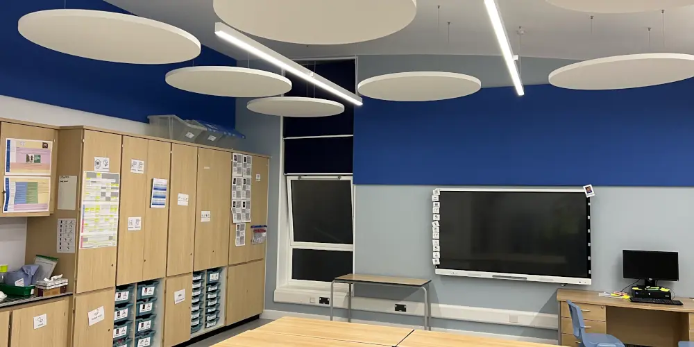 SEN classroom with blue acoustic wall panels and white circular ceiling rafts